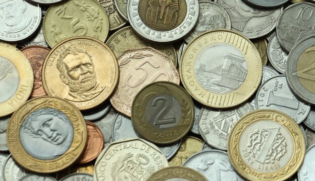 Big pile of coins from different money currencies. Treasure and numismatics concept