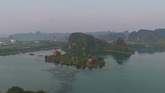 Golden pagoda island on a serene lake in hoa lu at sunrise