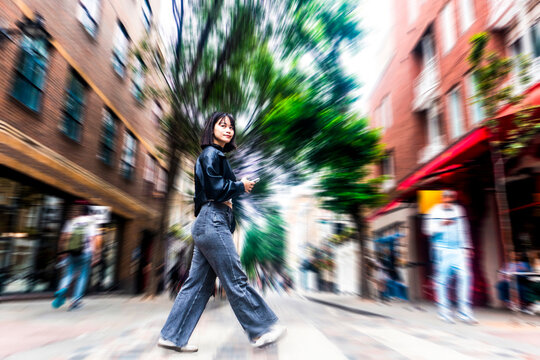 Happy woman walks along a London street