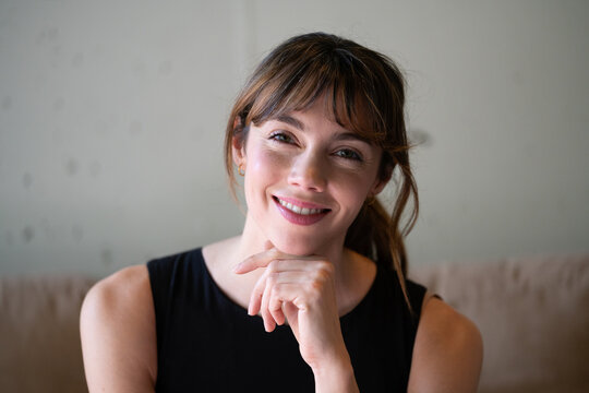Confident business portrait with hand on chin looking at camera