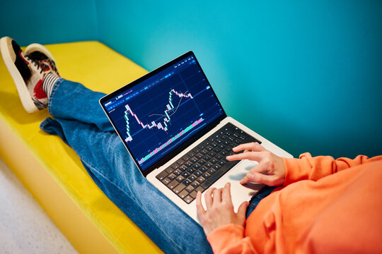 Businesswoman analyzes stock market chart on laptop