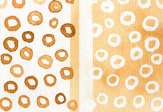 Abstract watercolor painting features ochre rings and copy space