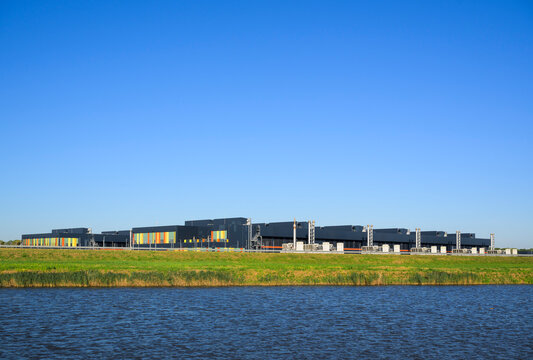 Modern data center building stands by a canal in Middenmeer