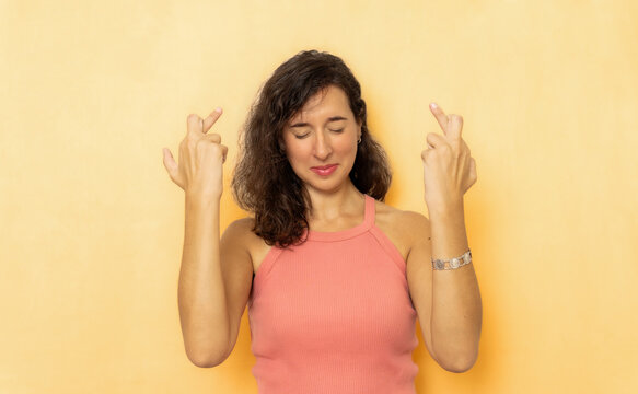 Woman crossing fingers for good luck and wishes