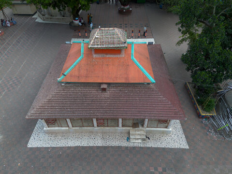 Aerial view of the Sri Sri Loknath Baba Mondir temple with its distinctive orange roof set within a tiled courtyard in Narayanganj, Dhaka, Bangladesh.