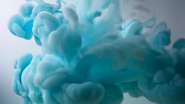 Turquoise ink clouds billow and diffuse through a pale underwater fluid field. Title sequences, motion graphics, and creative transitions.