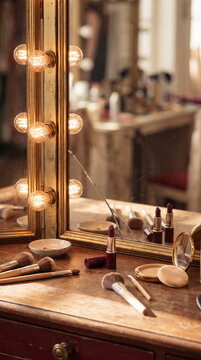 Dressing table with illuminated mirror and makeup tools in a studio  