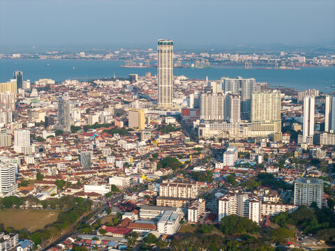 Skyline overlooks dense urban sprawl beside calm waters at George Town