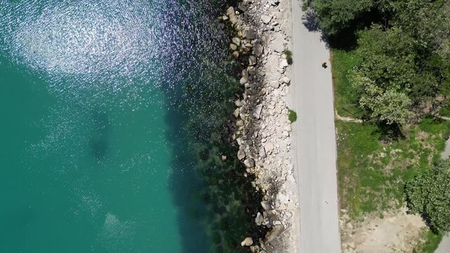Aerial Top Down View of Rocky Coastline Turquoise Sea Water and Road