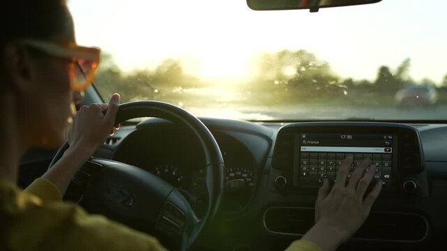 Female driver choosing  Paris as a destination on GPS screen