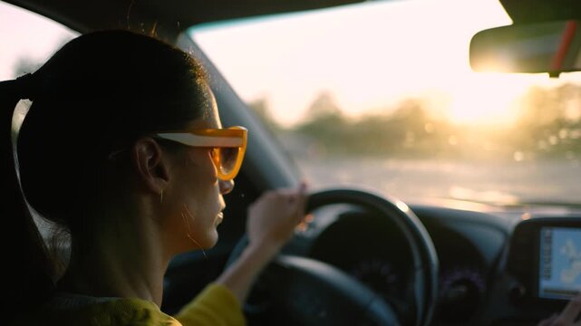 Female driver entering a travel destination into car navigation