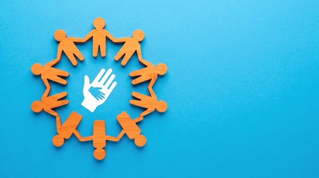 Wooden figures of people holding hands in a circle around a central hand icon representing community and unity