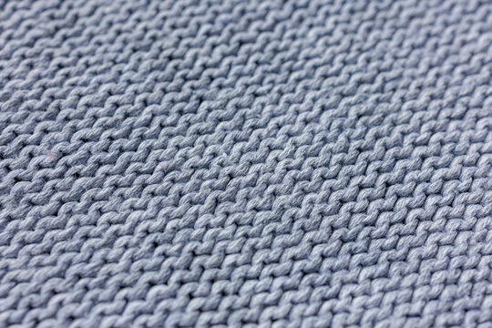 cool blue gray knitted textile with diagonal rows of soft yarn loops and subtle steel blue undertones