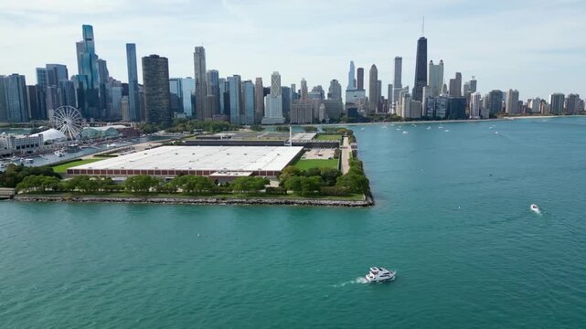 drone flying above boat in front of huge cityscape and lake