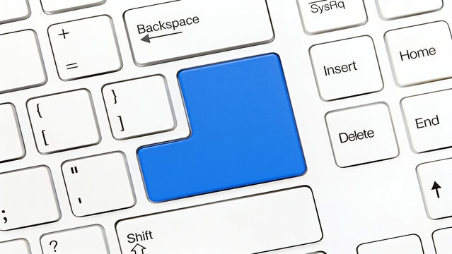 White computer keyboard featuring bold blank blue enter key