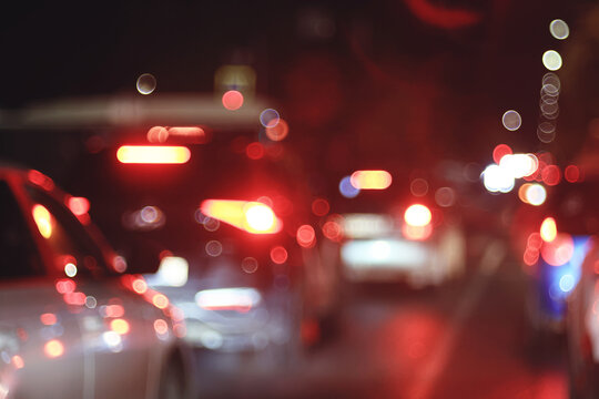Blurred Night Traffic: Defocused Car Lights Creating Urban Evening Bokeh