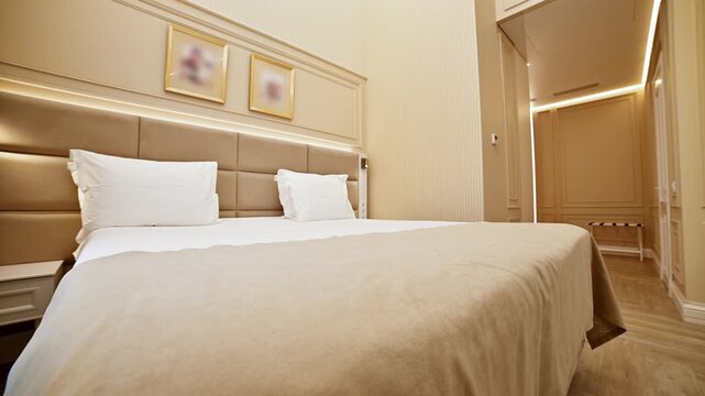 Dolly shot of modern luxury hotel room interior with bed