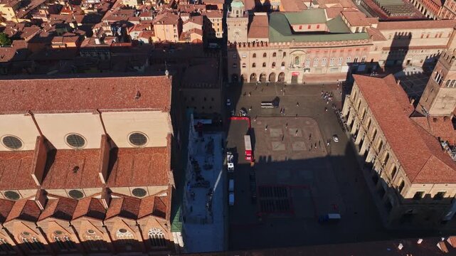 Aerial drone view of Basilica di San Petronio in Bologna, Italy, showcasing its monumental fa&ccedil;ade, historic architecture, Piazza Maggiore, and surrounding old town cityscape.