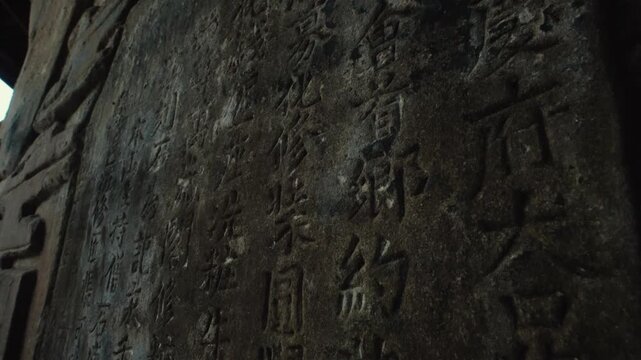 Dark close view of Chinese stone inscriptions at Baodingshan, Chongqing
