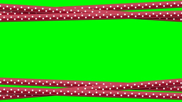 Red satin polka dot ribbons crossing to form a decorative holiday celebration border on a green screen.
