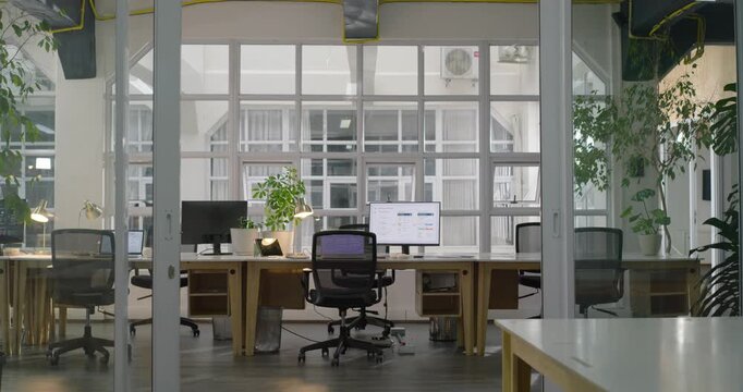 Camera is slowly moving forward and zooming in, revealing central workstation and monitor content