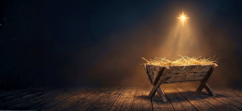 Empty rustic wooden Christmas nativity manger filled with straw beneath a glowing Bethlehem star and golden spotlight on dark background, reverent religious holiday scene with left copy space