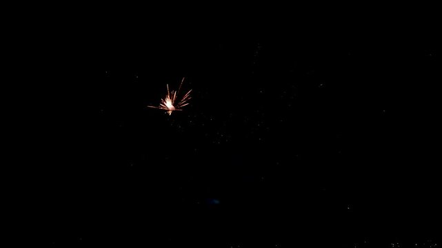 Spectacular red fireworks exploding and bursting with smoke in dark night sky during celebration, slow motion footage