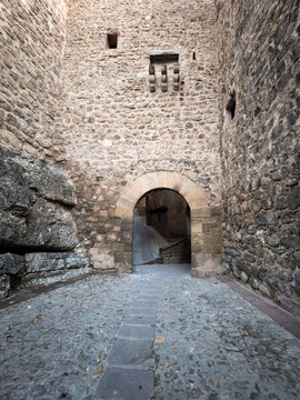 Albarrac&iacute;n medieval castle stone archway and cobbled street