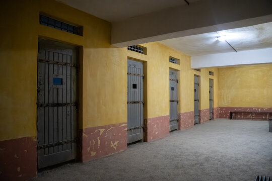 Interior view of old prison corridor with wooden cell doors.