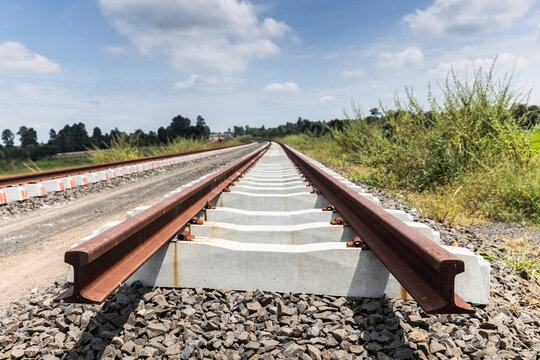 Unfastened Railway Rails on Concrete Sleepers Awaiting Installation of Rail Clips