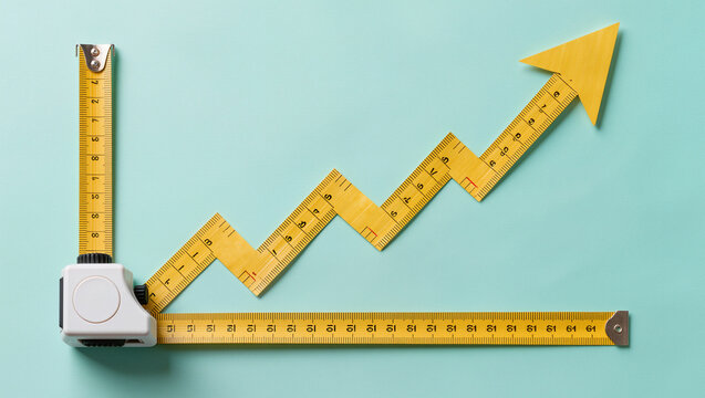 yellow tape measure bent into an upward zigzag arrow on a mint green surface, flat lay top view with clean light, conceptual measurable progress and growth tracking concept