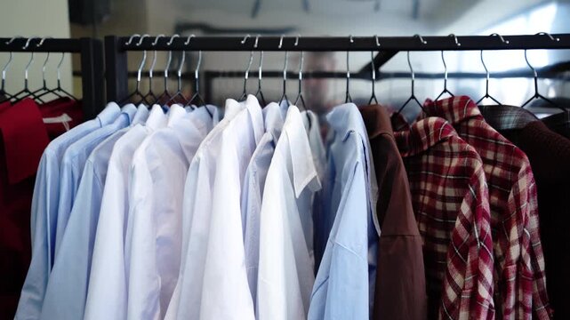 Clothes hanging on rack in boutique store