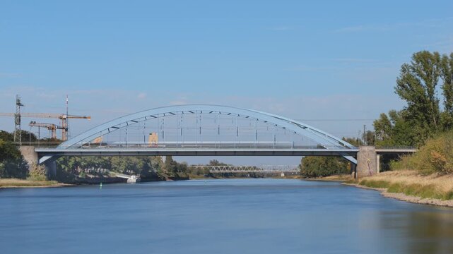 landscape in Magdeburg, Saxony-Anhalt, Germany, Jerusalembr&uuml;cke (Jerusalem Bridge) in foreground with Elbe River, time-lapse with motion blur, wide angle side view