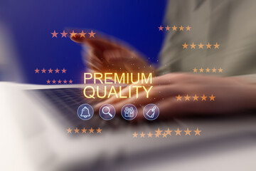 Person typing on a laptop with text about premium quality and stars in a blue background © yurakrasil