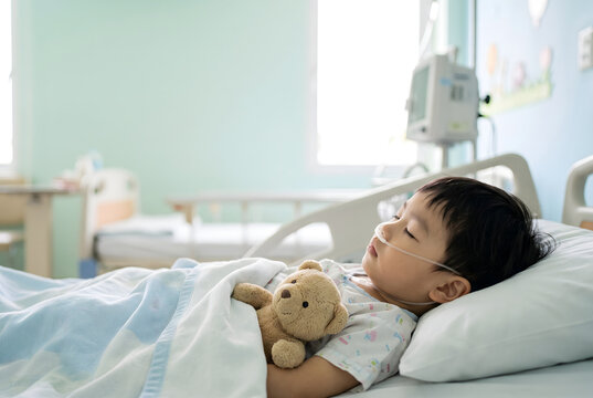 Young child sleeping in hospital bed with oxygen nasal cannula
