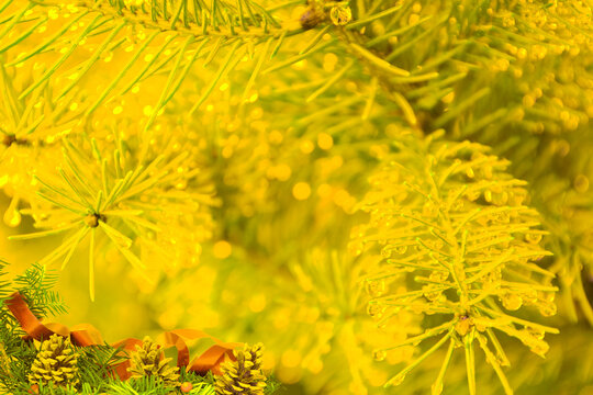 Golden Christmas Greeting Card with Pinecones and Sparkling Bokeh Lights Background