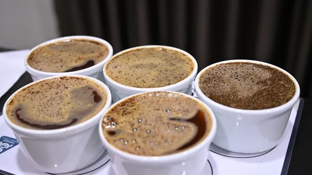 Professional barista smelling coffee for quality control