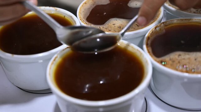Professional barista tasting and evaluating coffee quality
