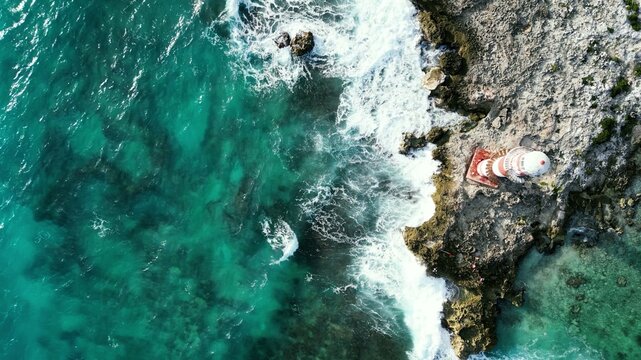 Aerial view of lighthouse above breaking surf in Mexico