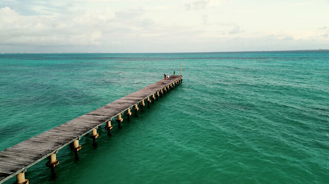 Aerial view of diagonal jetty over clear sea in Mexico