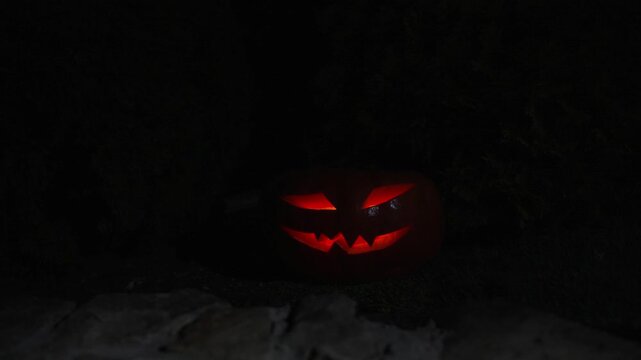 Subtle handheld camera movement around lit orange pumpkin as exterior lighting slowly dims outdoors, authentic 120fps halloween video asset