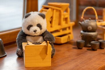 Stuffed Panda Toy with Wooden Tea Utensils and Teaware Setup © Валентина Хруслова