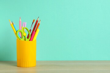 Bright modern minimalist stationery for schoolwork in a holder for office supplies on color background. Back to school concept. With space for copy space © Sunlight