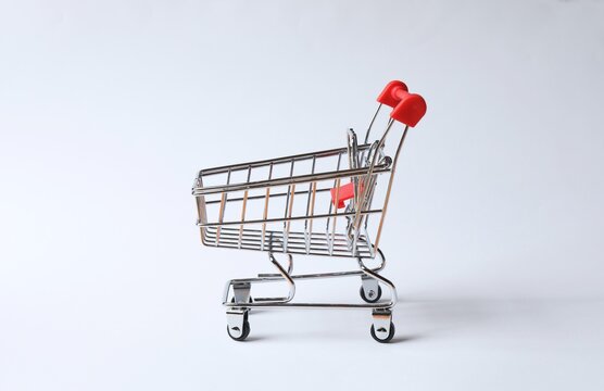 Small empty silver shopping cart on white background