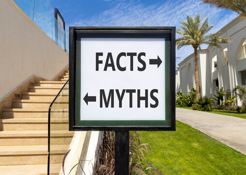 Facts or myths words symbol. Concept words Myths and Facts on beautiful white road sign. Beautiful palm trees background. Business and facts or myths concept. Copy space.