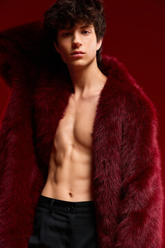 Bold winter fashion with muscular young man in faux fur coat