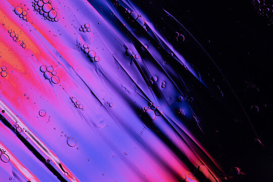 Water and oil forming abstract purple pink gradient bubbles