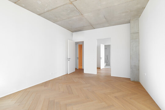 Modern empty apartment room interior mockup with white walls, column, and view to bathroom.