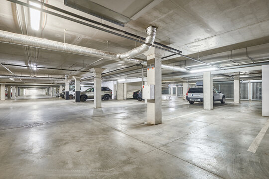 Modern empty underground parking garage interior and concrete columns