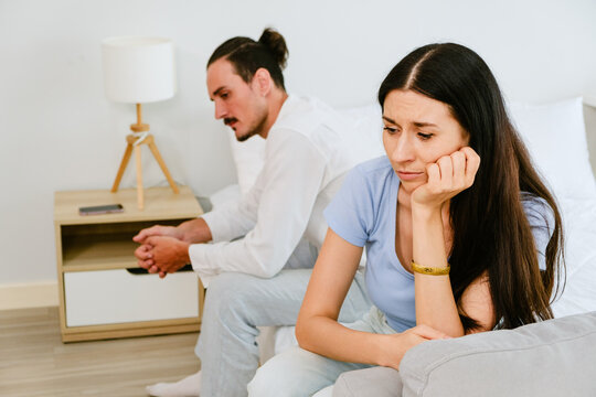 Unhappy Couple Sitting Apart After Relationship Conflict at Home
